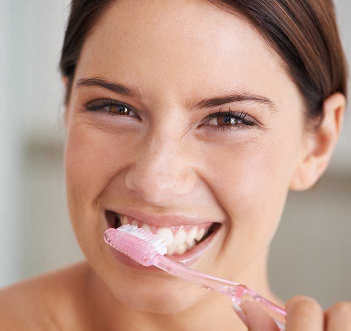 woman brushing her teeth